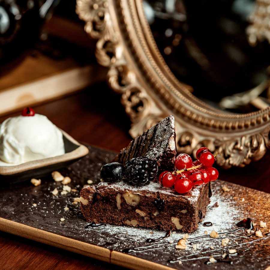 portioned-chocolate-cake-garnished-with-chocolate-syrup-berries_140725-5050